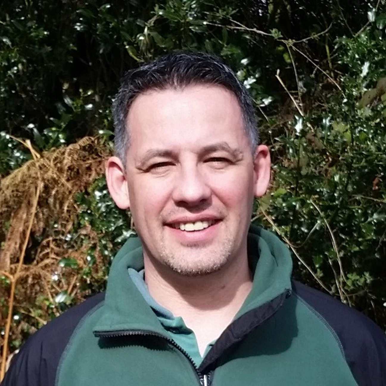 User-supplied photograph identified as Rob Gazzard, standing outdoors in front of foliage